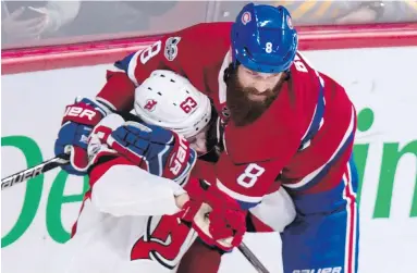  ??  ?? Canadiens defenceman Jordie Benn (8), a North Saanich product, wraps up Devils’ Jesper Bratt Thursday night.