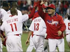  ?? THE ASSOCIATED PRESS FILE ?? Then-Phillies bench coach Larry Bowa, right, gives a highfive to then-Phillies shortstop Jimmy Rollins after his home run beat the Miami Marlins April 12, 2014.