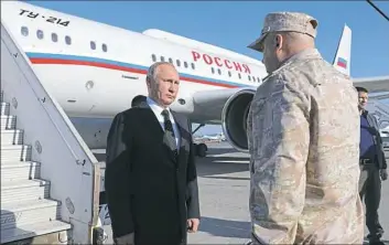  ?? Mikhail Klimentyev, Sputnik/Kremlin Pool via AP ?? Russian President Vladimir Putin listens to the report of Col.Gen. Sergei Surovikin, Russian Commander in Syria, at the Hemeimeem air base in Syria, on Monday.