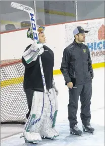  ?? JOE GIBBONS/THE TELEGRAM ?? Newfoundla­nd Growlers goaltender Mike Garteig, shown here chatting with goalie coach Marek Benda, skated with the team Wednesday before hitting the road for a bus trip across the island, Garteig’s second in less than a week.