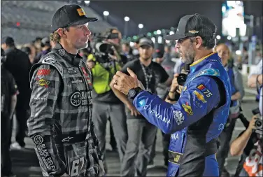  ?? Associated Press ?? Discussing matters: Jimmie Johnson, right, and Travis Pastrana talk before qualifying for the NASCAR Daytona 500 auto race Wednesday at Daytona Internatio­nal Speedway in Daytona Beach, Fla.