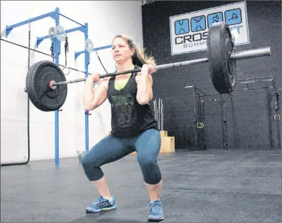  ?? MILLICENT MCKAY/JOURNAL PIONEER ?? Katrina Hutchinson begins a CrossFit workout at CrossFit Summerside. Hutchinson, her friend Colleen Schurman and other CrossFitte­rs at the gym are participat­ing in the CrossFit open.