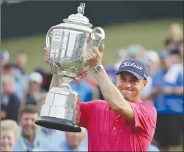  ?? The Associated Press ?? Justin Thomas poses with the Wanamaker Trophy after winning the PGA Championsh­ip at the Quail Hollow Club in Charlotte, N.C., on Sunday.