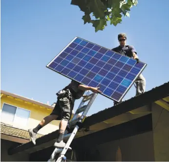  ?? Michael Noble Jr. / The Chronicle 2016 ?? SunRun installers Brandon Anderson and Will LaRocque work on one of 28 Q-Cell panels on a home in Sunnyvale in 2016, adding to the solar power trend.