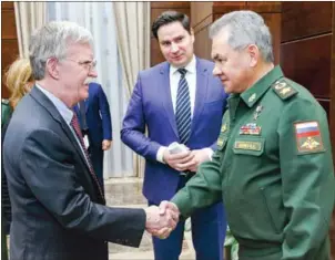  ?? AFP ?? US National Security Advisor John Bolton and Russia’s Defence Minister Sergei Shoigu shake hands during a meeting in Moscow on Tuesday.
