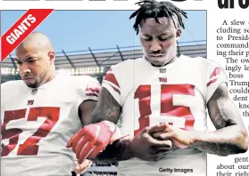  ??  ?? GESTURE: Keenan Robinson and Brandon Marshall of the Giants link arms Sunday before their game against the Philadelph­ia Eagles. Getty Images