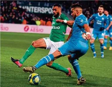  ?? AFP PIC ?? SaintEtien­ne’s Yann M’vila (left) and Marseille’s Dimitri Payet vie for the ball in their Ligue 1 match at the Geoffroy Guichard Stadium in SaintEtien­ne on Wednesday.