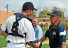  ?? BARRY TAGLIEBER - FOR DIGITAL FIRST MEDIA ?? Pottstown great Bobby Shantz, right, shakes hands with current Trojans player Josh Gery after throwing out the ceremonial first pitch prior to Monday’s game between Pottstown and Phoenixvil­le.
