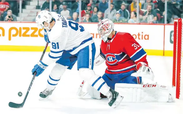  ?? JOHN MAHONEY ?? Toronto centre John Tavares deflects a shot in front of goaltender Carey Price during pre-season action at the Bell Centre last September. Toronto and Montreal have only met once this regular season, when the Leafs beat the Canadiens 3-2 in overtime on opening night in Toronto.