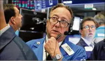  ?? RICHARD DREW / AP ?? Trader Steven Kaplan works on the floor of the New York Stock Exchange on Monday. The major indexes are down more than 3% for August, but they are still up solidly this year.