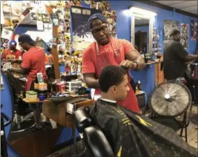  ?? NICHOLAS BUONANNO — NBUONANNO@TROYRECORD.COM ?? Naquin Walls, owner of Foreva Fly Cuts, cuts hair Tuesday afternoon.