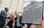  ?? Steve Helber / Associated Press ?? Virginia Gov. Terry McAuliffe , right, looks over a marker that commemorat­es the 50th anniversar­y of the end of the ban on interracia­l marriage.