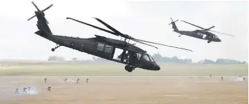  ??  ?? A pair of UH-60 Black Hawk helicopter­s take part in the Han Kuang drill at the Ching Chuan Kang (CCK) air force base in Taichung, central Taiwan.