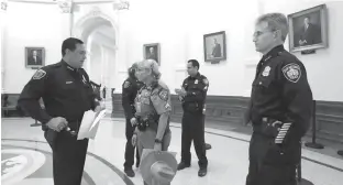  ?? Associated Press ?? n Houston Police Chief Art Acevedo, left, and San Antonio Police Chief William McManus, right, stand with other law enforcemen­t officers in the rotunda Tuesday at the Texas Capitol as they wait to speak against a proposed “bathroom bill” at a public...