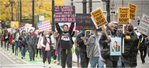  ?? PAT NABONG/SUN-TIMES ?? Protesters march Saturday from Federal Plaza to Daley Plaza in the Loop during the Women’s March.