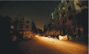  ?? (Ammar Abdullah/Reuters) ?? DAMAGED BUILDINGS are pictured under a star-lit sky overnight between Tuesday and Wednesday in Idlib, Syria, about 60 km. southwest of Aleppo.