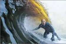  ?? Kelly Slater Wave Co. ?? I N AN I MAGE from a video, Kelly Slater gets a tube ride on a wave created by machine on a piece of old farmland in California.