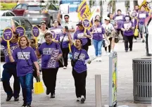  ?? Karen Warren/Staff photograph­er ?? Around 250 people marched Saturday in downtown Houston in support of janitors organized with SEIU Texas who are seeking full-time status and benefits as well as higher pay.