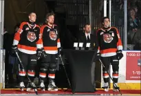  ?? NEWS PHOTO JAMES TUBB ?? The Medicine Hat Tigers three overage defencemen, Bogdans Hodass, Rhett Parsons and Dru Krebs, pose while accepting their overage gifts from the Medicine Hat Hockey Hounds during a team award ceremony ahead of a 4-3 overtime loss to the Lethbridge Hurricanes on March 23 at Co-op Place.