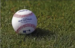  ?? ROSS D. FRANKLIN ?? FILE - In this Feb. 17, 2017, file photo, a baseball is shown on the grass at the Cincinnati Reds baseball spring training facility in Goodyear, Ariz.