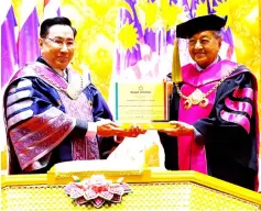  ??  ?? Dr Mahathir receives the honorary doctorate in social leadership, business and politics from Dr Arthit. — Bernama photo