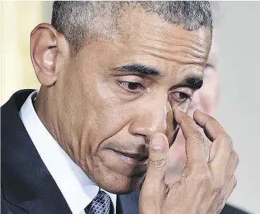  ?? MANDEL NGAN / AFP / GETTY IMAGES FILES ?? U. S. President Barack Obama wipes a tear Tuesday as he speaks on gun violence.