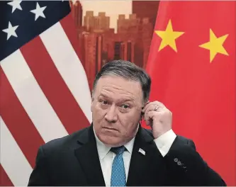  ?? ANDY WONG THE ASSOCIATED PRESS ?? Mike Pompeo listens a question during a joint press conference with Chinese Foreign Minister Wang Yi.