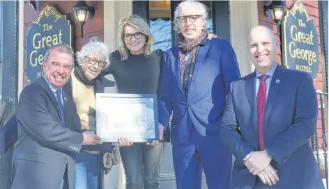  ?? MITSUKI MORI/THE GUARDIAN ?? Kevin and Kathy Murphy are the recipients of the Catherine G. Hennessey Award for 2019. Shown with them outside their Charlottet­own hotel, The Great George, are Mayor Philip Brown, left, award-namesake Catherine Hennessey and Coun. Greg Rivard. The annual award recognizes a group or individual who has fostered the city’s heritage.