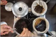  ?? (AP/Vernon Yuen) ?? Students stir tea in a pot during a class.