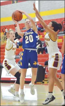  ?? Staff photo/ Jake Dowling ?? St. Marys’ Cora Rable ( 20) attempts a second- half jump shot with New Bremen’s Madison Cordonnier (12) and Riley Trentman ( 24) guarding during a non-league girls basketball game on Tuesday.