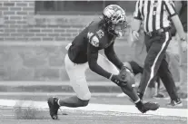  ?? KARL MERTON FERRON/BALTIMORE SUN ?? Maryland defensive back Tarheeb Still scoops up a fumble by Kent State running back Marquez Cooper to squash a scoring threat in the second quarter Saturday in College Park. The Terps’ defense stood strong in the red zone in a 37-16 win.