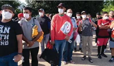  ?? The Associated Press ?? Migrants hold Red Cross blankets on April 27 after arriving at Union Station near the U.S. Capitol in Washington. The Pentagon has rejected a request from the District of Columbia seeking National Guard assistance for the thousands of migrants being bused to the city from two southern states.