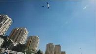  ?? (Marc Israel Sellem/The Jerusalem Post) ?? ‘THE CITY looks amazing from the sky.’ A parachutis­t drifts over Sacher Park yesterday.