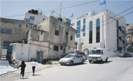  ?? UNRWA ?? Top, Saudi Arabia funded the $4 million health centre in Aida camp; left, residents use the games area at the centre, run by the UN agency for Palestinia­n refugees