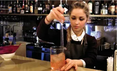  ?? PICTURE: LIZA WEISSTUCH /THE WASHINGTON POST. ?? CAUSING A STIR: At Time Social Bar, bartender Eleonora Contessi concocts an Italian riff on a rye-whiskey-based Sazerac, a classic American cocktail.