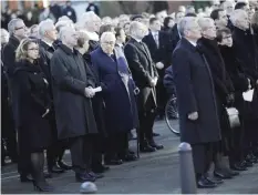  ??  ?? HAMBURG: Former US Secretary of State Henry Kissinger, center talks to German Chancellor Angela Merkel as they leave the church after the official memorial service for former Chancellor Helmut Schmidt in Hamburg, yesterday. — AP