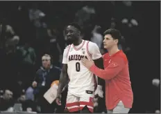  ?? JOSÉ LUIS VILLEGAS/AP ?? ARIZONA GUARD COURTNEY RAMEY (0) is consoled as he leaves the floor following a first-round loss to Princeton in the NCAA Tournament in Sacramento, Calif. on Thursday.