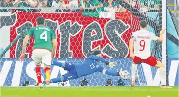  ?? — AFP photo ?? Mexico goalkeeper Guillermo Ochoa saves a penalty shot by Lewandowsk­i.