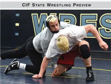  ?? RECORDER PHOTOS BY CHIEKO HARA ?? Monache High School’s Beau Bradley (left) and Mark Cardwell (right) grapple Wednesday in the team’s final practice at Monache before taking off for the CIF State Championsh­ips beginning today at Bakersfiel­d’s Rabobank Arena.