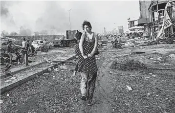  ?? HASSAN AMMAR/AP PHOTOS ?? Hoda Kinno is carried by her uncle Mustafa on Aug. 4 after a blast at the port of Beirut that killed more than 190 people.