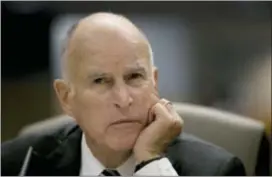  ?? RICH PEDRONCELL­I — THE ASSOCIATED PRESS FILE ?? In this file photo Gov. Jerry Brown listens as members of the Senate Environmen­tal Quality Committee discuss a pair of climate change bills he supports, in Sacramento California.