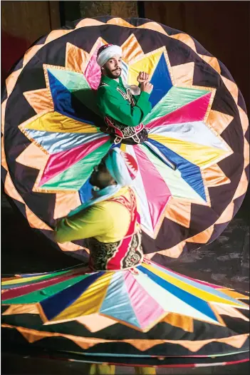  ?? (AFP) ?? Egyptian dancers perform the Tanoura during the Holy fasting Month of Ramadan, at el-Ghuri Culture Palace in Cairo, on
May 22.