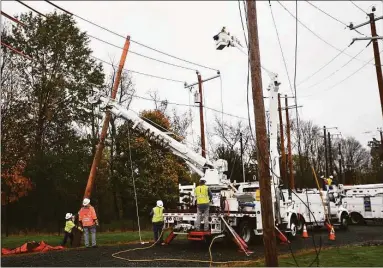  ?? Brian A. Pounds / Hearst Connecticu­t Media file photo ?? Eversource Energy workers demonstrat­e the steps involved in power restoratio­n at the company’s training site in Berlin on Oct. 28, 2020.