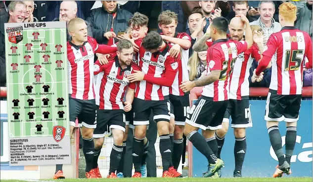  ?? PICTURES: TGSPHOTO ?? MOBBED: Brentford players congratula­te Alan Judge after notching their second goal