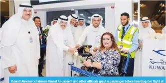  ??  ?? Kuwait Airways’ chairman Yousef Al-Jassem and other officials greet a passenger before boarding her flight at Kuwait Internatio­nal Airports’ newly-built terminal 4 yesterday.