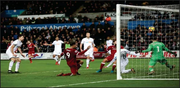  ??  ?? Roberto Firmino had an excellent chance to rescue a point for Liverpool at the death but could only hit the far post with his header back across goal