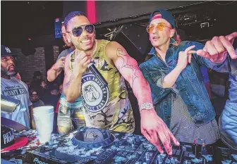  ?? PHOTO COURTESY OF BIG NIGHT ENTERTAINM­ENT GROUP ?? Nelly and DJ Clinton Sparks, far right, spin at Shrine Nightclub.