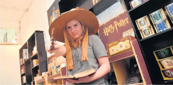  ??  ?? > Claire McCartney’s shop in Castle Arcade, Cardiff, which sells official Harry Potter merchandis­e