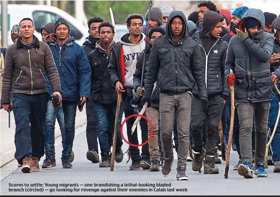  ??  ?? Scores to settle: Young migrants — one brandishin­g a lethal-looking bladed branch (circled) — go looking for revenge against their enemies in Calais last week