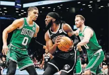  ?? [FRANK FRANKLIN II/THE ASSOCIATED PRESS] ?? The Brooklyn Nets’ Demarre Carroll is defended by the Boston Celtics’ Jayson Tatum and Gordon Hayward during the first half Monday in New York.